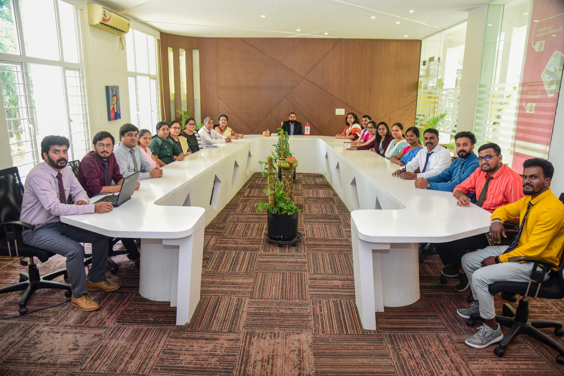 Redbridge Staff & Management seated around a conference table - the leadership and teaching team that powers the academy.